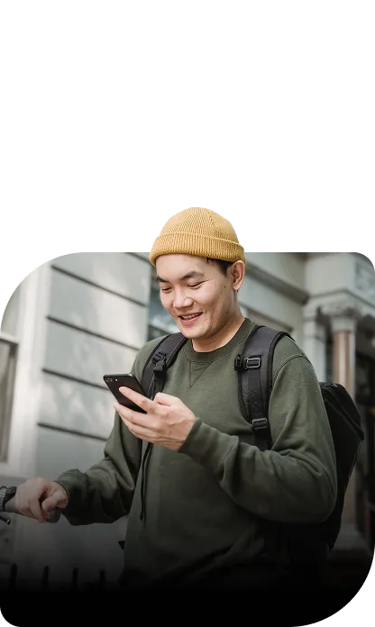 A fan reading a message on their phone in the street